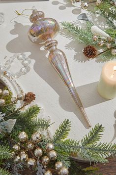 a candle and some ornaments on a table