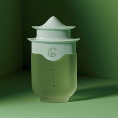 a green cup with a white lid on it