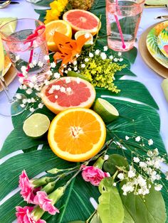 the table is set with oranges, grapefruits and other tropical flowers