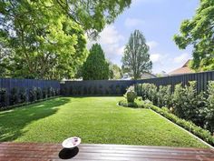 a wooden deck with a frisbee on it in the middle of a yard