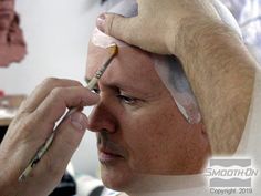 a man getting his hair cut by someone