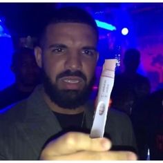 a man holding up a toothbrush in his hand