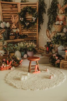 a small stool sitting on top of a table in front of some baskets and plants