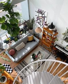 a living room filled with furniture and lots of plants