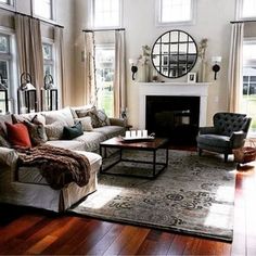 a living room filled with furniture and a fire place