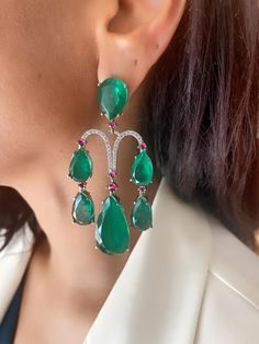 Discover the allure of our Green Emerald Ruby Silver Diamond Chandelier Earrings. These stunning earrings feature a captivating combination of emerald and ruby stones set in silver, adorned with sparkling diamonds. Perfect for adding a touch of elegance to any outfit. Luxury Green Sterling Silver Bridal Earrings, Green Diamond Chandelier Drop Earrings, Luxury Green Dangle Chandelier Earrings, Elegant Green Ruby Jewelry, Green Gemstone Accented Earrings For Party, Green Gemstone Accent Earrings For Party, Elegant Green Gemstone Chandelier Earrings, Elegant Green Emerald Chandelier Earrings, Emerald Diamond Earrings