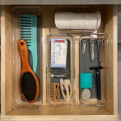 an organized drawer with combs, hair brushes and other personal care items in it