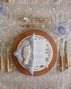 a place setting on a table with utensils and napkins