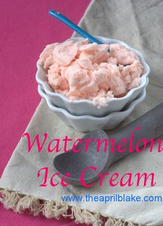 a white bowl filled with ice cream on top of a pink table cloth next to a spoon