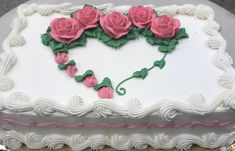 a heart shaped cake decorated with pink roses