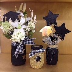 three mason jars with flowers and stars on them