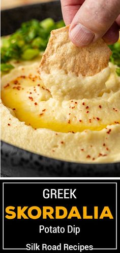 a hand dipping a piece of bread into a skillet filled with potatoes and broccoli