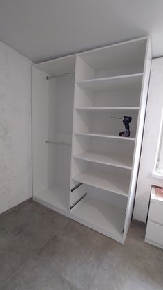 an empty closet with shelves and tools in it