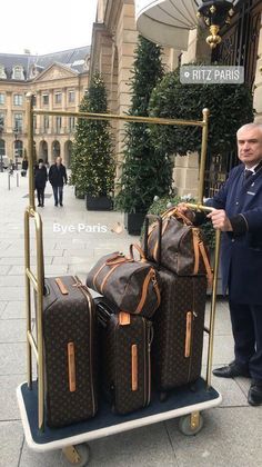 a man standing next to luggage on a cart