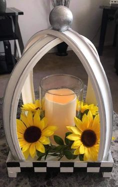 a candle holder with sunflowers and a vase