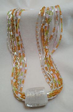 This is an artist favorite.  Start with a hand-made opalescent glass bead that just radiates all kinds of beautiful colors and then hang it from a luxurious 14 strand beaded chain.  It doesn't just look wonderful, it also feels wonderful; it's just like silk around your neck.  The strands themselves reflect all of the opalescent colors that glisten from the bead.  Truly a gorgeous statement piece. Luxury Statement Multi-strand Beaded Necklace, Toggle Necklace, Tucson Az, Glass Bead Necklace, Multi Strand, Beaded Chain, Glass Bead, An Artist, Bead Necklace