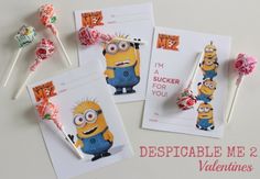 minion lollipops and valentine's day cards on a white table