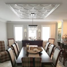 a dining room table with chairs and a tray on it