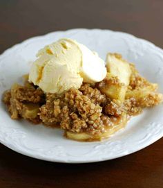 a white plate topped with apple crisp and ice cream