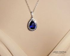 Wedding Sapphire Royal Blue Navy Blue Cubic Zirconia Teardrop Halo Pendant with .925 Sterling Silver Chain Bridal Necklace. Glamorous and elegant, this necklace is perfect for weddings or special occasions such as birthdays, anniversaries, graduations, proms...or whatever you can imagine! CHAIN is 18 inches (45.7 cm) long. PENDANT is about 1.18 inch (3cm) long including bail. Handmade necklace, is made with .925 Sterling Silver 18 inches long cable chain, Rhodium Plated pear shaped Sapphire Navy Blue Teardrop Drop Necklace For Formal Occasions, Formal Blue Teardrop Drop Necklace, Formal Blue Drop Necklace, Elegant Blue Teardrop Drop Necklace, Blue Teardrop Necklace For Wedding, Sapphire Crystal Bridal Necklace Gift, Blue Teardrop Jewelry For Wedding, Blue Drop Jewelry For Wedding, Blue Teardrop Wedding Jewelry