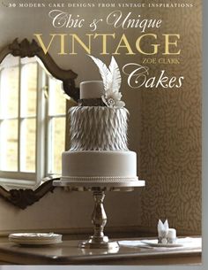 an advertisement for a cake shop with white frosting and feathers on the front cover