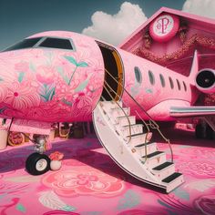 an airplane painted pink with floral designs on the side and stairs leading up to it