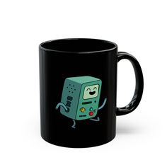 a black coffee mug with an image of a green computer character on it's side