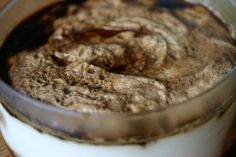 a glass jar filled with pudding on top of a wooden table