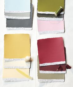 four different shades of paint sitting next to each other on top of a sheet of paper