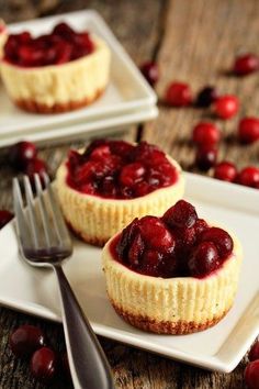 two small desserts with cranberry sauce on white plates next to silverware