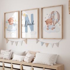 three framed pictures hang on the wall above a wooden bench with pillows and pillow cases