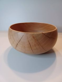 a wooden bowl sitting on top of a table