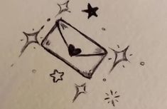 a drawing of a kite with hearts and stars in the sky, on top of a sheet of paper