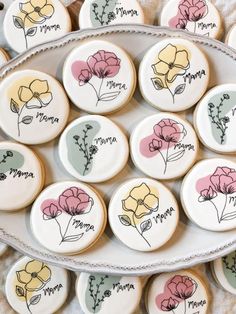 decorated cookies with flowers are on a platter