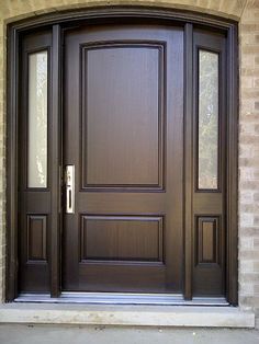 the front door is made of wood and has two sidelights on each side,