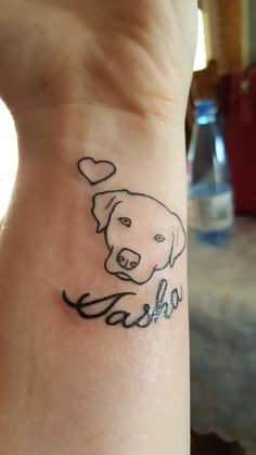 a dog with a heart on it's wrist is shown in this tattoo design