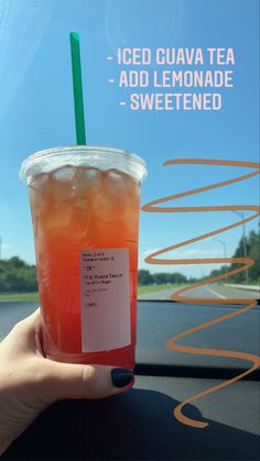 a person holding up a drink in front of a car window with the words iced guava tea - add lemonade - sweetened