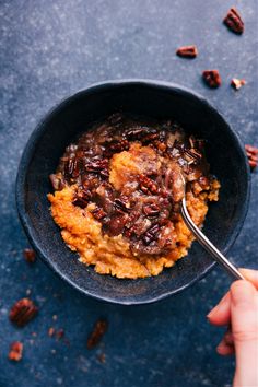 a bowl filled with mashed sweet potatoes and pecans