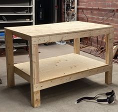 a wooden table being built with tools on the ground