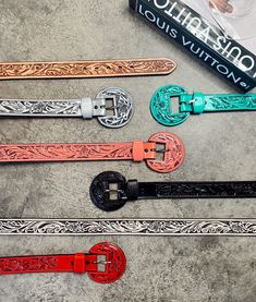 These beautiful tooled belts are made of genuine leather. Definitely a must have belt because it is SO versatile! You can wear it as a fashion statement with your favorite turquoise buckle or wear it to the next rodeo you're entered in. Buckle is removable. Handmade in Mexico. Available in black, champagne, natural, pink, red, silver & turquoise. Available in 30”, 32”, 34”, 36” & 38”. Jacie wears a size 26" pant & wears a size 30" belt! Suggested Sizing: 24"-26" Pants = 30" Belt 27"-28" Pants = Tooled Belts, Vogue Home, Tooled Belt, Pink Belt, Western Style Outfits, Wild Rag, Tool Belt, Åland Islands, Central African