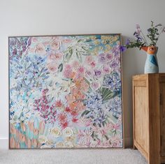 there is a painting on the wall with flowers in it