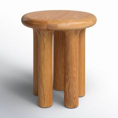 a small wooden stool sitting on top of a white floor