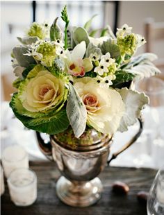 a vase filled with white flowers on top of a table