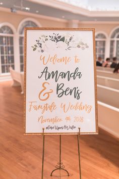 a welcome sign for the newly married couple in front of a room full of people