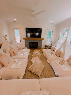 a living room filled with lots of white furniture