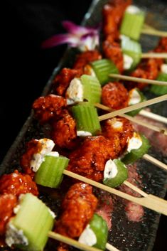 skewered meat and vegetables on a tray with toothpicks in the foreground