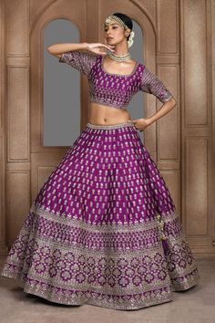 Purple attached cancan panelled lehenga with zari thread, sequin embroidery in floral pattern. Paired with half sleeve padded blouse and dupatta.
Components: 3
Pattern: Embroidery
Type Of Work: Zari thread, sequin, floral
Neckline: U neck
Sleeve Type: Half
Fabric: Raw Silk
Color: Purple
Other Details: 
Lehenga Length: Approx 45-46 inches
Panelled lehenga
Side and back tassel tie-up
Sheer embroidered dupatta
Occasion: Bride - Aza Fashions Navratri Brocade Choli With Cutdana Detail, Navratri Brocade Choli With Cutdana, Floor-length Brocade Lehenga With Cutdana, Purple Semi-stitched Brocade Sets, Traditional Brocade Choli With Dori Work, Fitted Banarasi Silk Lehenga With Cutdana, Fitted Banarasi Silk Lehenga With Dori Work, Festive Purple Raw Silk Lehenga, Purple Dola Silk Lehenga With Cutdana