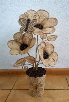 a vase filled with flowers on top of a wooden floor covered in burlocks