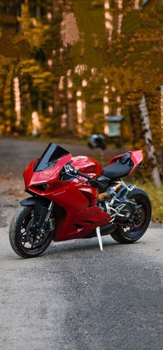 a red motorcycle is parked on the street