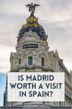 a sign that says is madrid worth a visit in spain? with an eagle on top